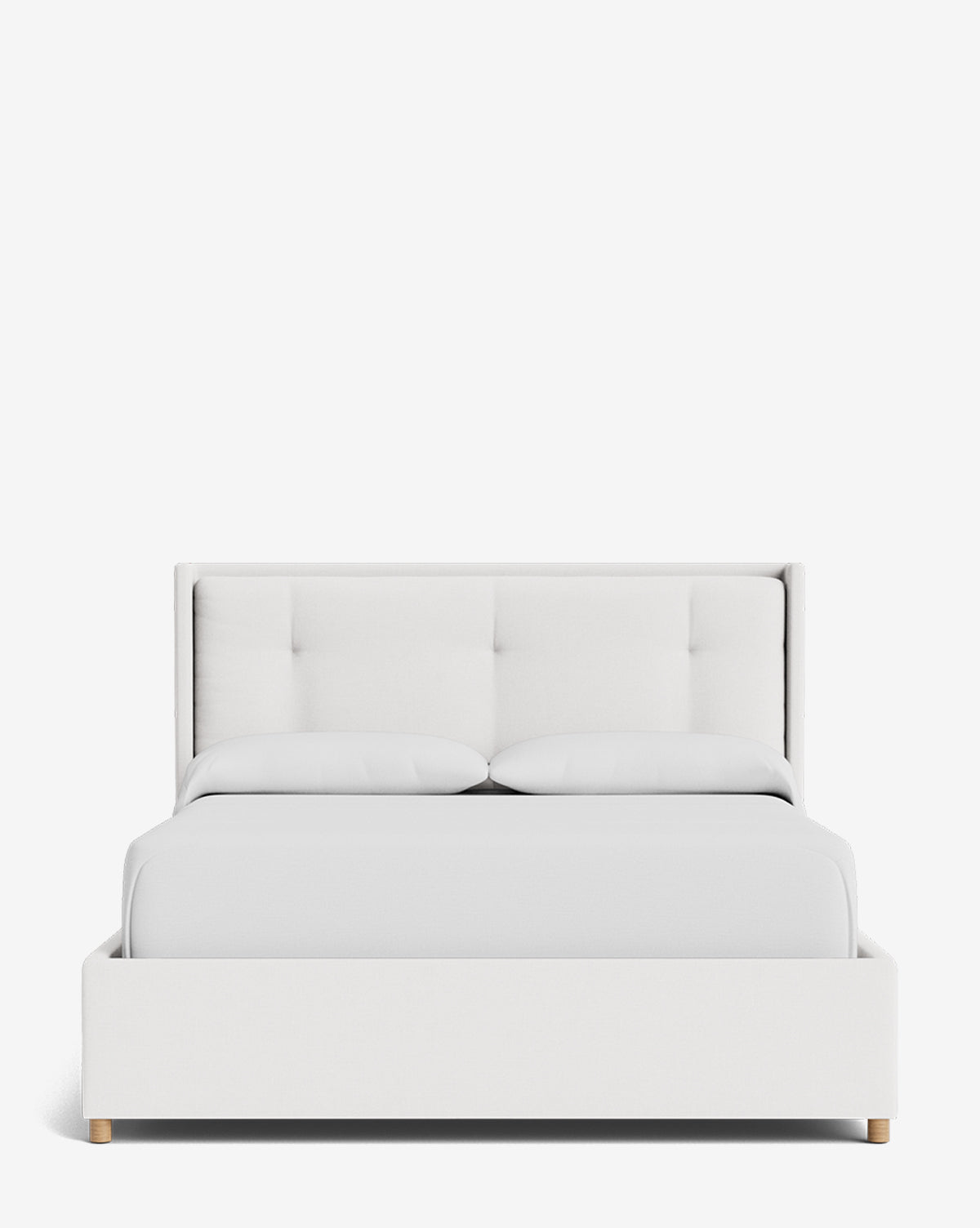 The Ria Bed Low Headboard is shown from the front against a white background, featuring clean lines, a tufted headboard, white bedding with two pillows, and small wooden legs by McGee & Co.