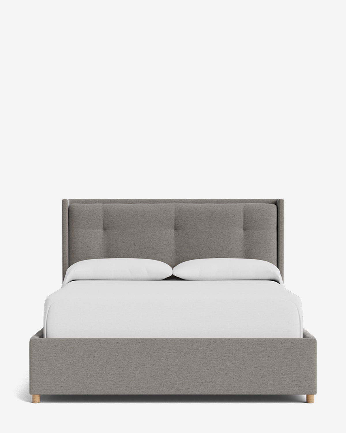 The Ria Bed Low Headboard features a modern gray tufted headboard and frame, white bedding, two pillows, and light wood legs—all set against a plain white background by McGee & Co.