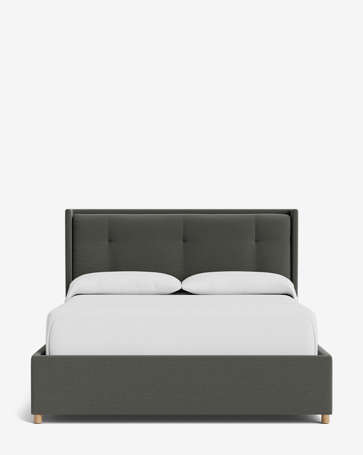 The Ria Bed Low Headboard showcases a modern design with dark gray upholstery, a tufted headboard, light wood legs, crisp white bedding, and two white pillows by McGee & Co.