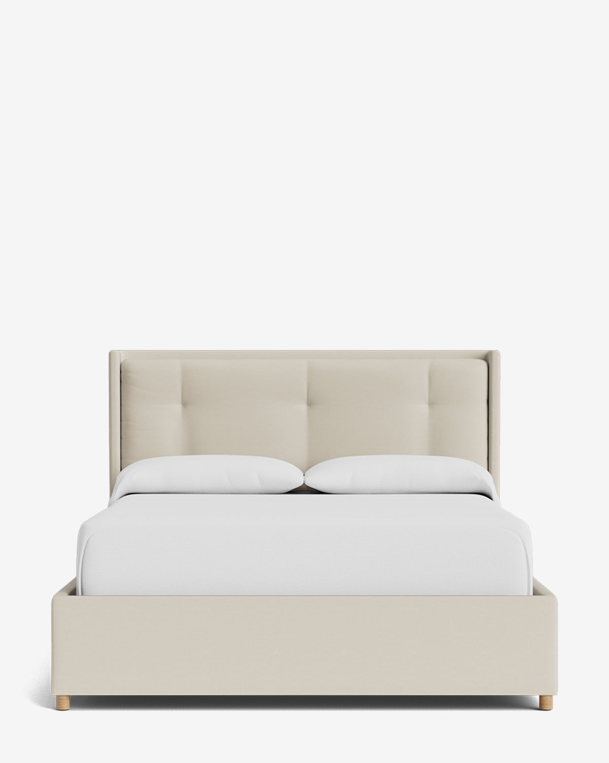 The Ria Bed Low Headboard, shown from the front against a plain white background, features beige upholstery, a modern tufted headboard, white bedding, and light wooden legs, by McGee & Co.