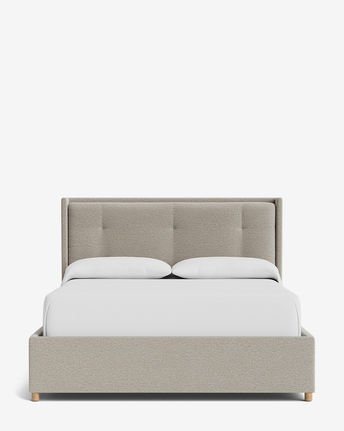 The Ria Bed Low Headboard is a beige upholstered bed with a tufted headboard and light wood legs, neatly made with white bedding and two pillows, displayed against a plain white background, by McGee & Co.