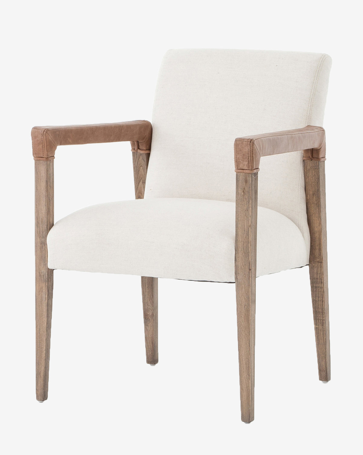 The Robby Dining Armchair features light beige upholstery, wooden legs, and brown leather armrest accents, displayed against a plain white background for a modern, elegant look, by McGee & Co.