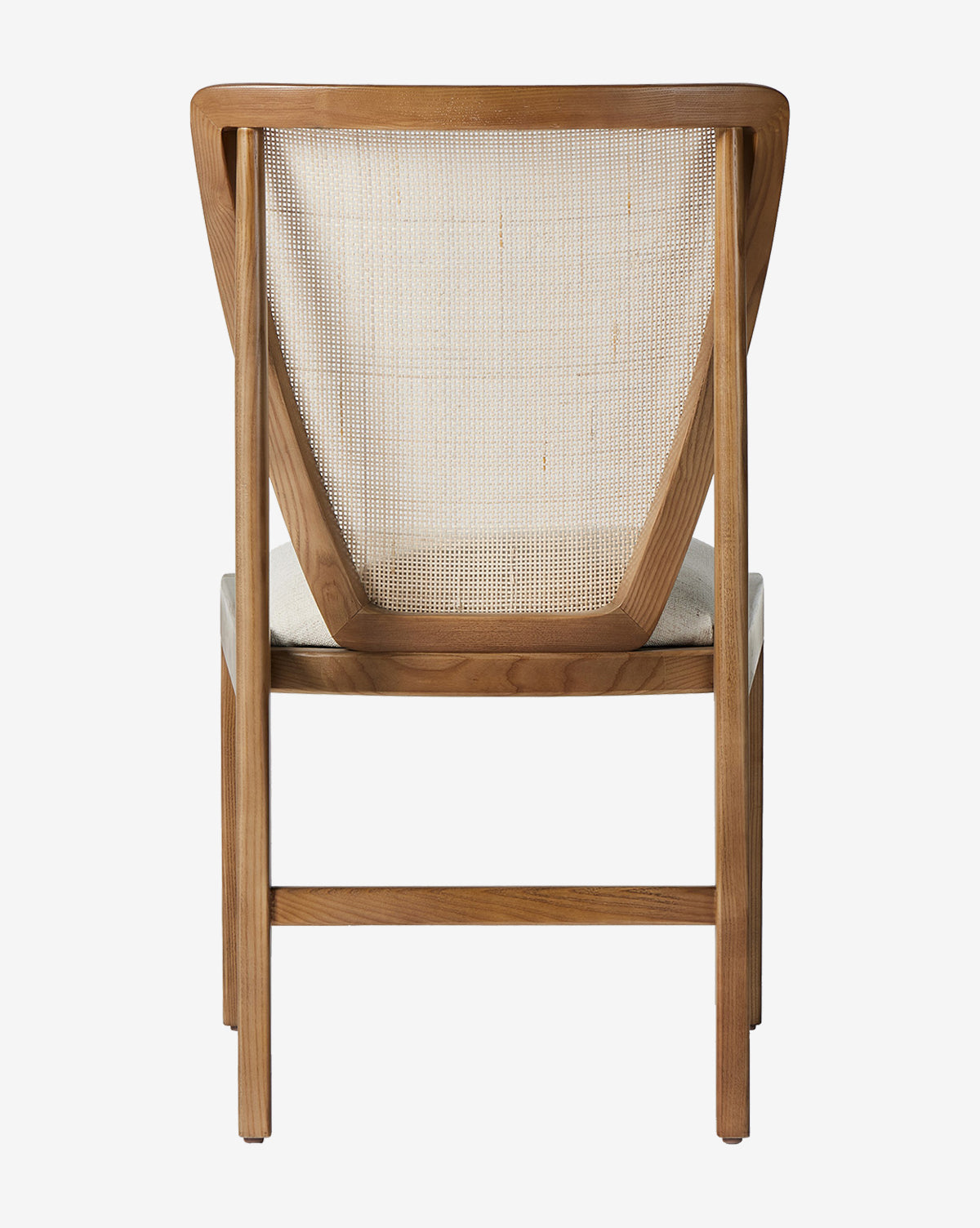 The Rogan Dining Chair features a curved wooden frame, cane back mesh, and a light cream performance fabric cushioned seat, displayed from the back against a white background by McGee & Co.