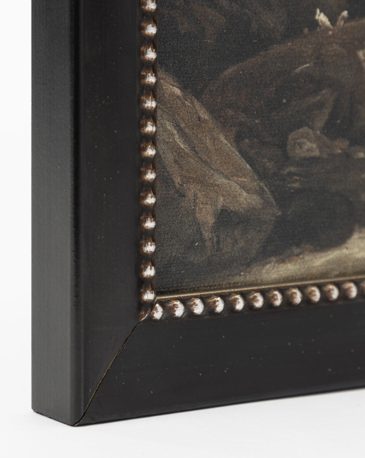Close-up of the bottom left of Rough Sea Shores, a gallery-quality framed painting. It features a dark wooden frame with a beaded edge and mitered joint; the artwork inside shows muted, dark tones evoking a windswept shoreline, by McGee & Co.