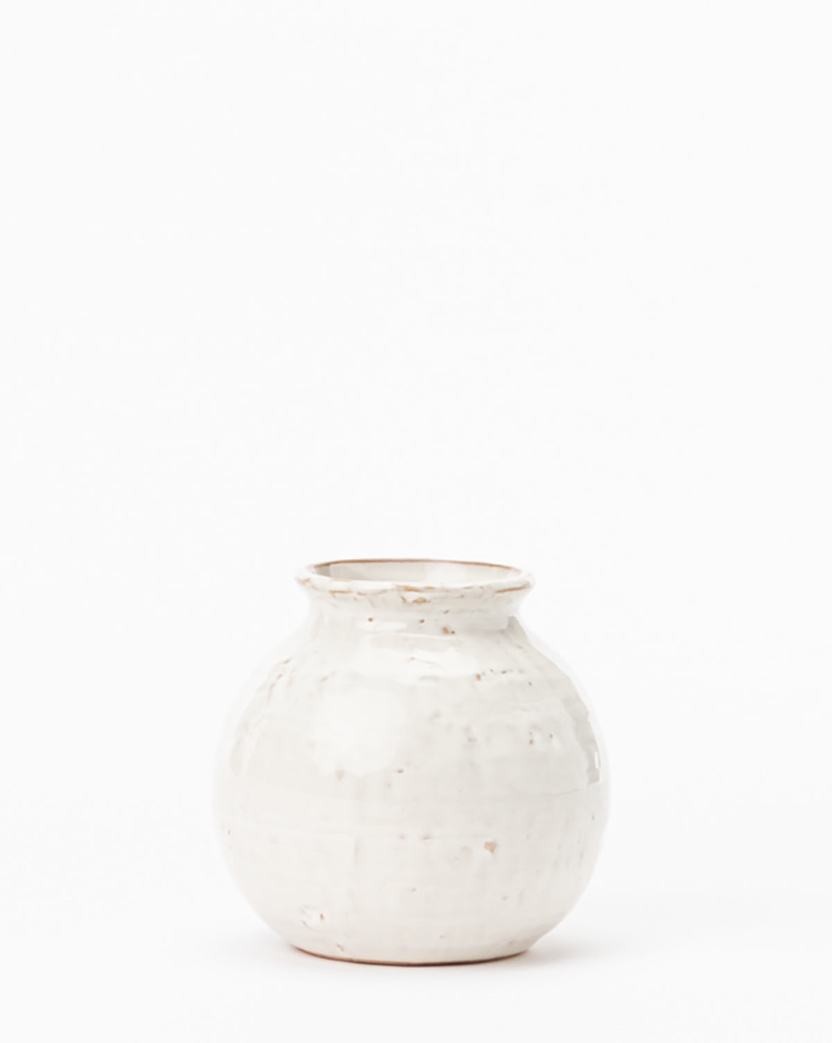 The Rounded Ceramic Vase features a small, rounded design with a narrow opening and subtle distressed glaze. Perfect for adding elegant style to your home decor. Displayed on a plain white background.