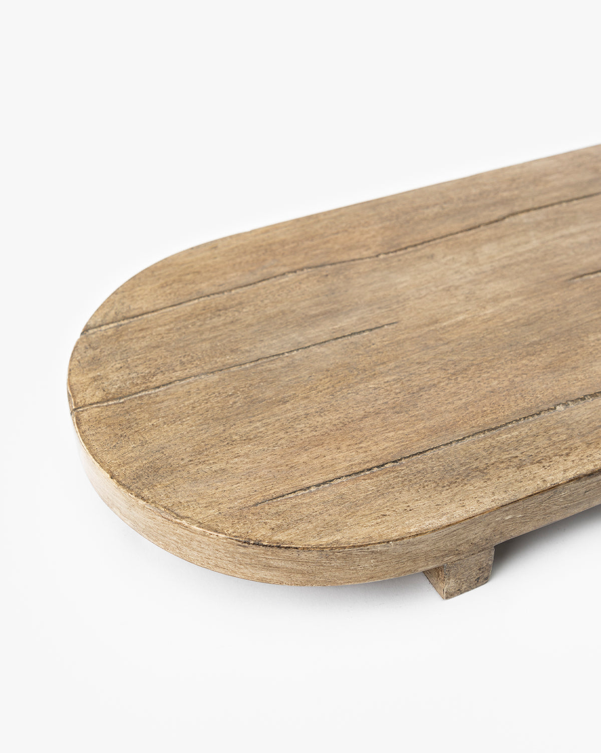 A close-up of the Rounded Edge Bath Caddy, featuring a rustic, oval design with an organic wooden texture and two short legs, set against a plain white background.