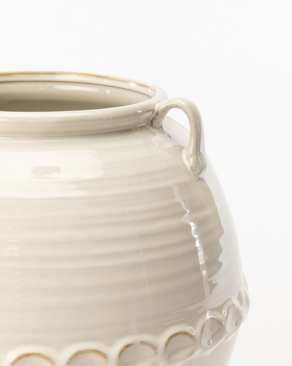 A close-up of the Rounded White Vase, featuring textured horizontal ridges and a small handle near the rim, displayed against a plain white background.