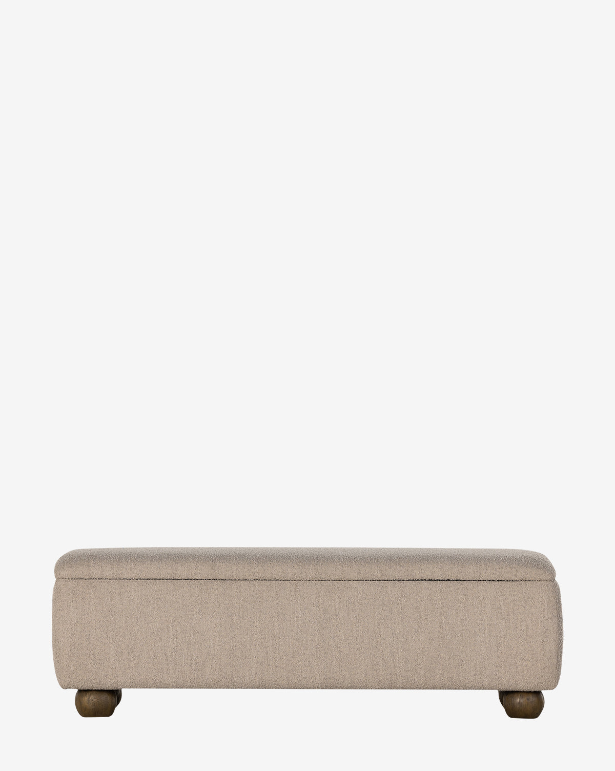 The Rowley Trunk by Four Hands is a rectangular beige upholstered storage trunk with rounded corners and short wooden legs in a modern design, shown against a plain white background. McGee & Co.