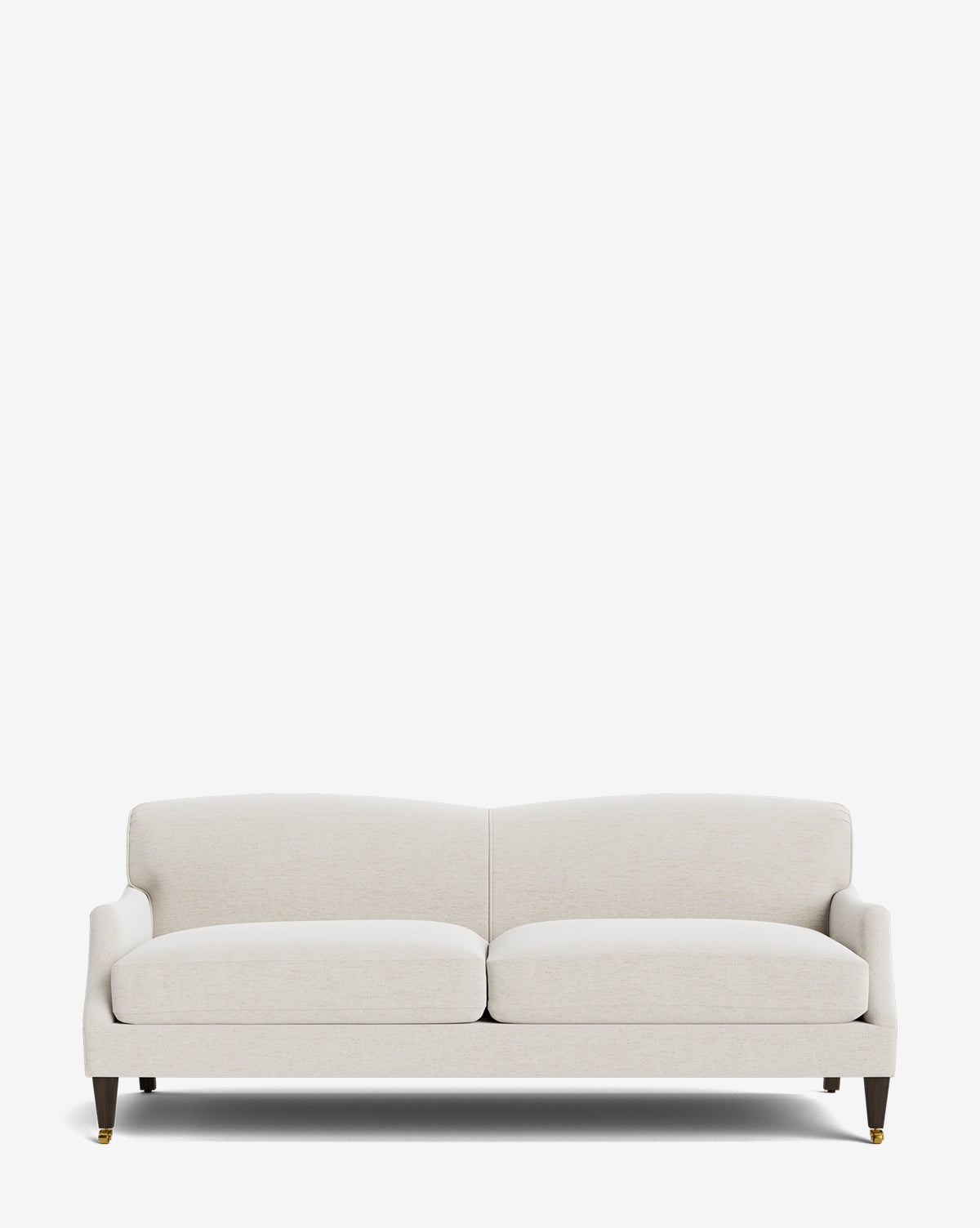 The Rowley Sofa 85 is a modern, light beige upholstered hand-crafted sofa with two seat cushions, wooden legs, and brass caster wheels on the front legs, shown against a plain white background by McGee & Co.