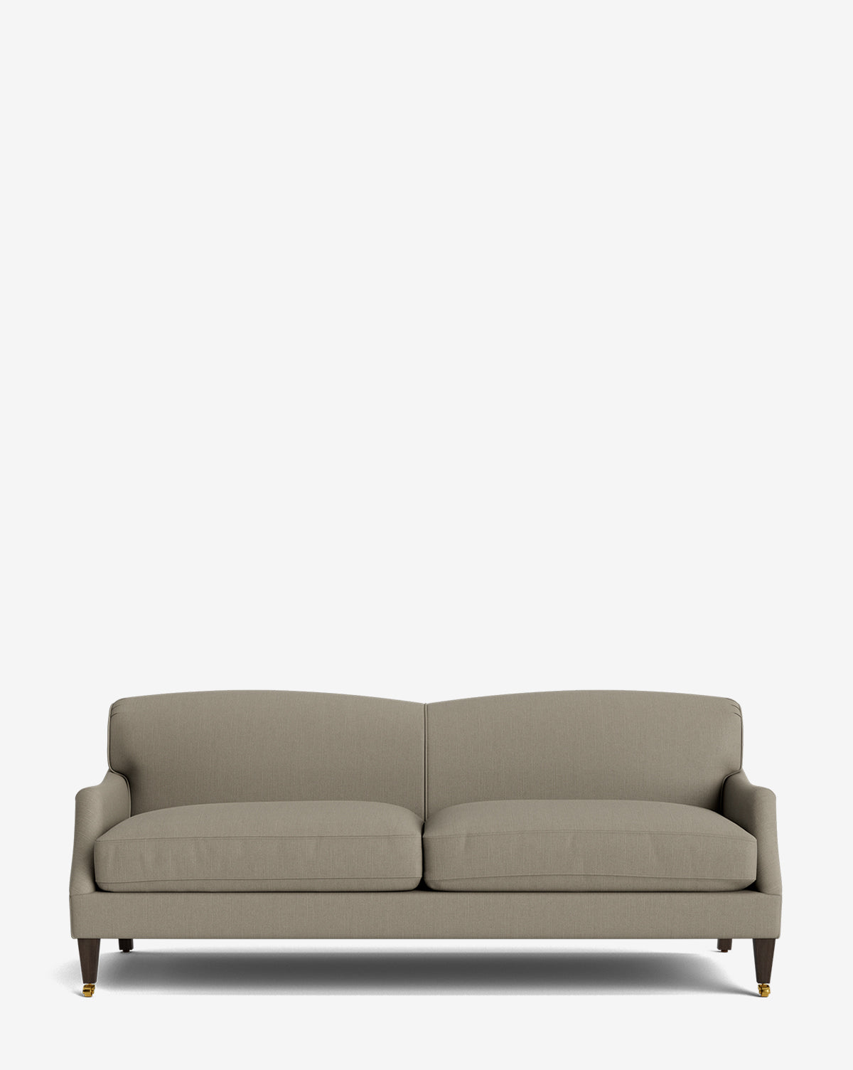The Rowley Sofa 85 is a modern, hand-crafted light gray upholstered sofa with two seat cushions, low arms, and wooden legs featuring brass casters, shown against a plain white background by McGee & Co.