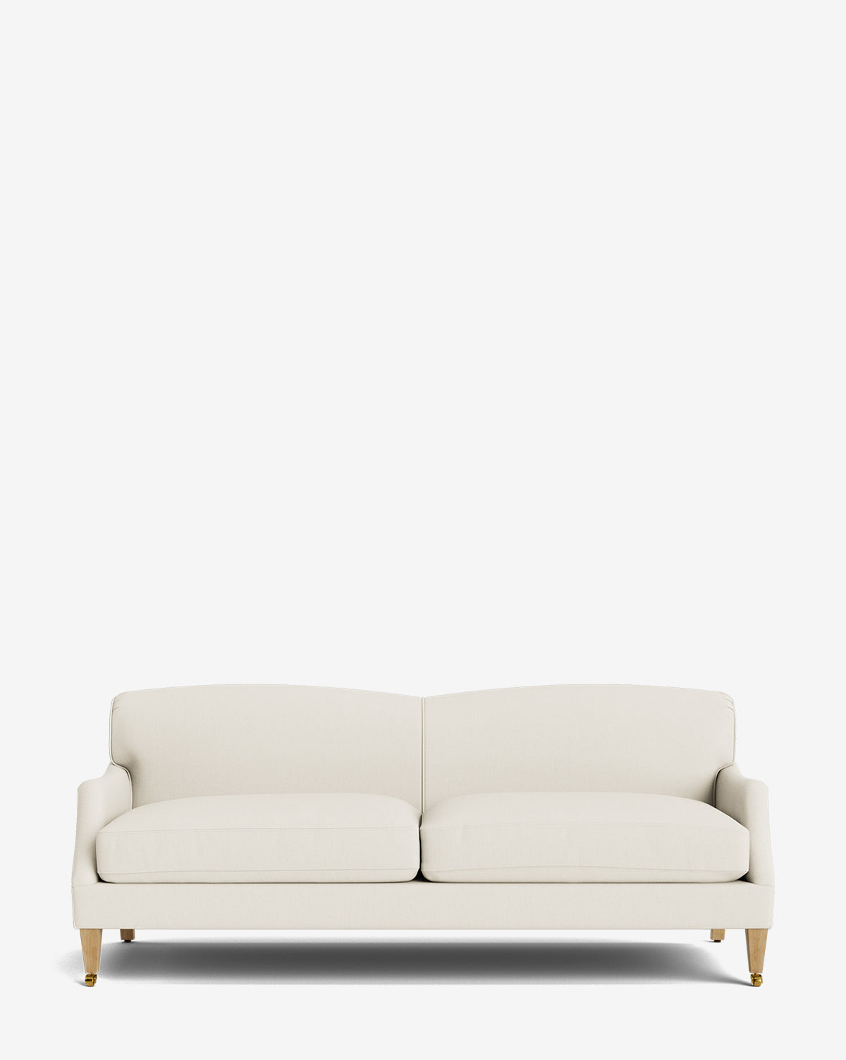 The Rowley Sofa 85 is a modern, cream hand-crafted sofa with two seat and back cushions, light wooden legs with gold caps, shown against a plain white background by McGee & Co.