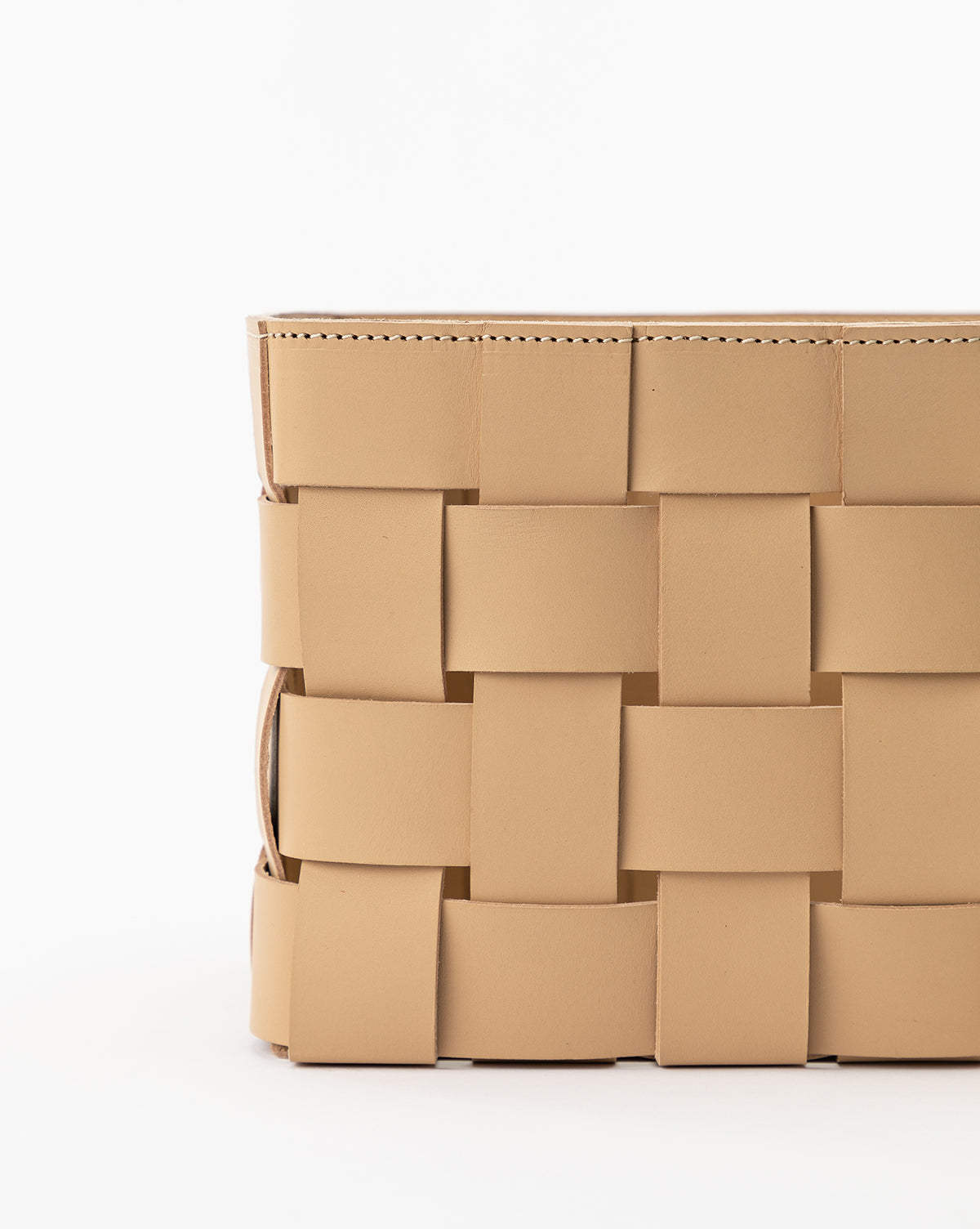Close-up of the Rupert Leather Bin in beige, featuring large overlapping woven leather panels—an ideal stylish addition to your home office—shown against a plain white background.