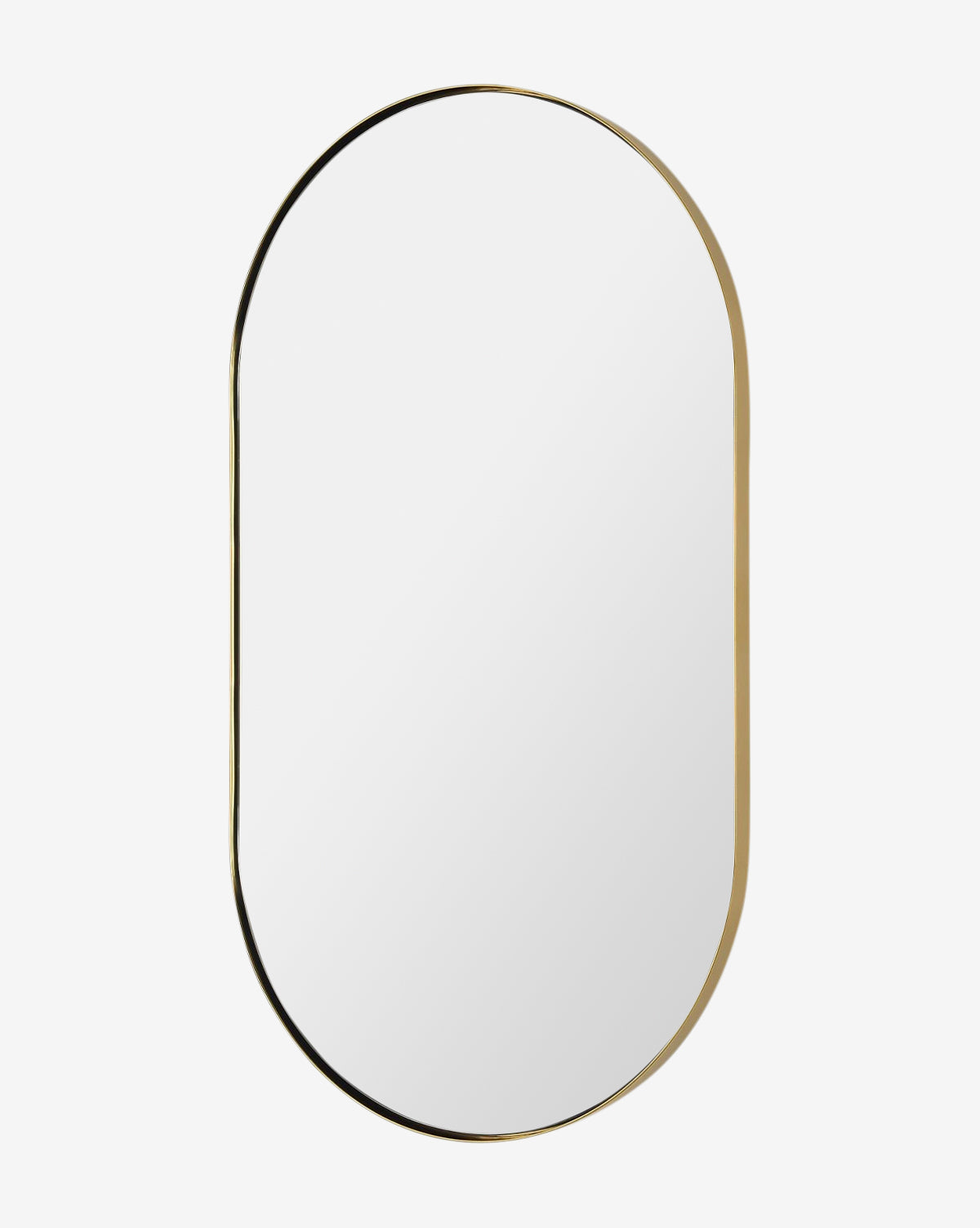The Rye Wall Mirror features an oval design with a slim gold metal frame, bringing modern elegance to any white wall, by McGee & Co.