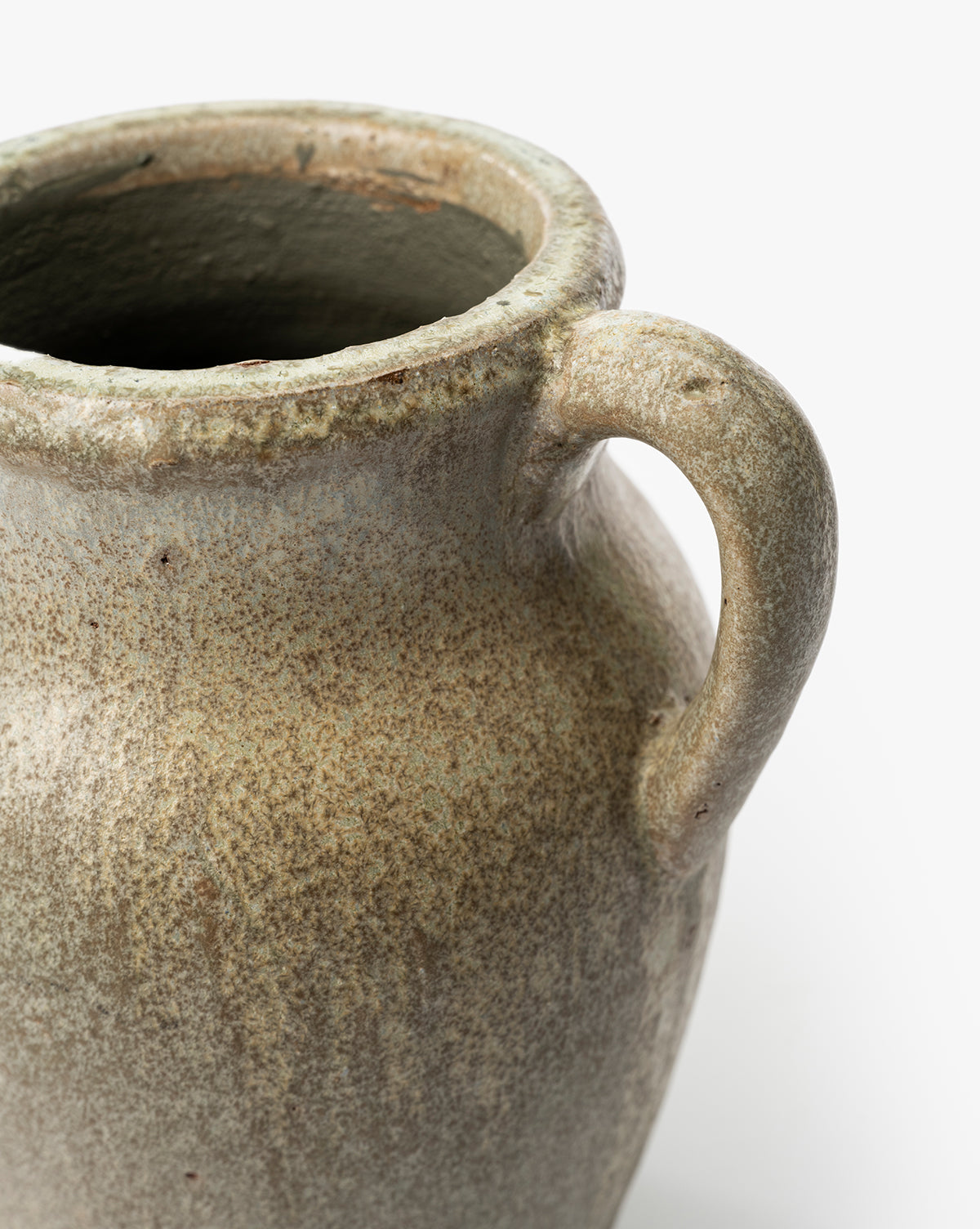 A close-up of the Sabine Pitcher Vase, a vintage-inspired ceramic jug with a single handle, speckled earthy glaze, and rough texture, shown against a plain white background, by McGee & Co.