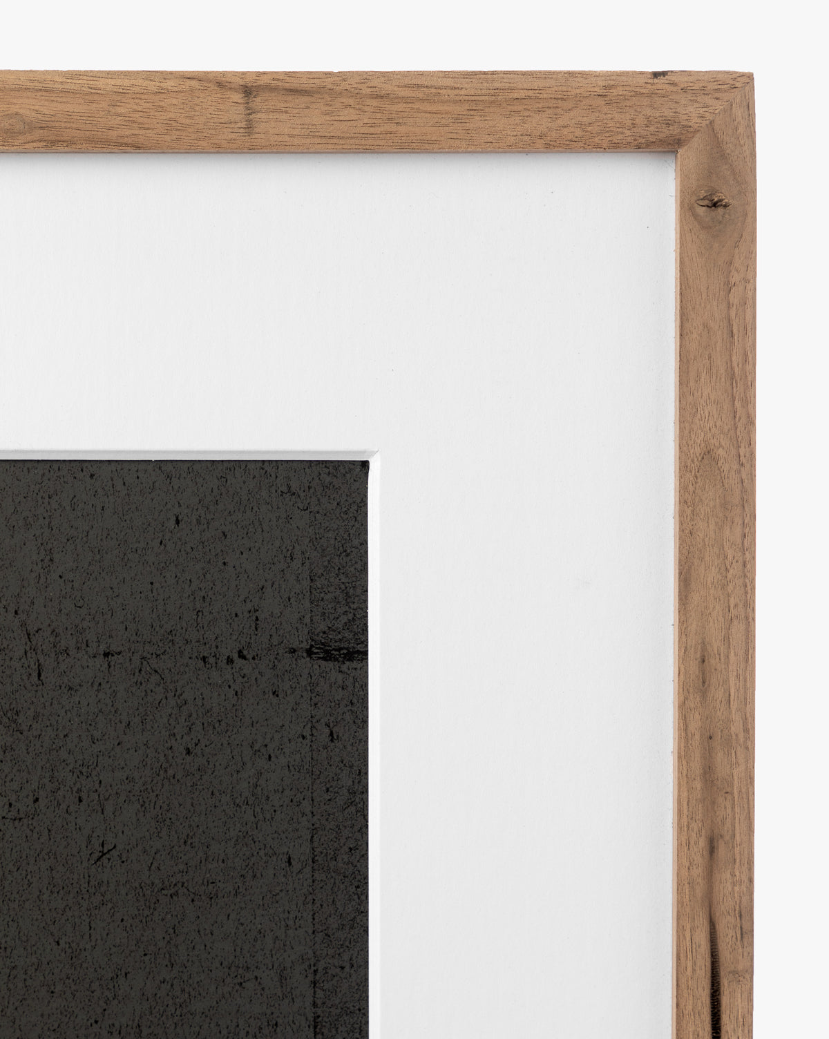 Close-up of the top right corner of a rustic walnut frame with a white mat, showcasing the abstract giclee print Safe by Dan Hobday.