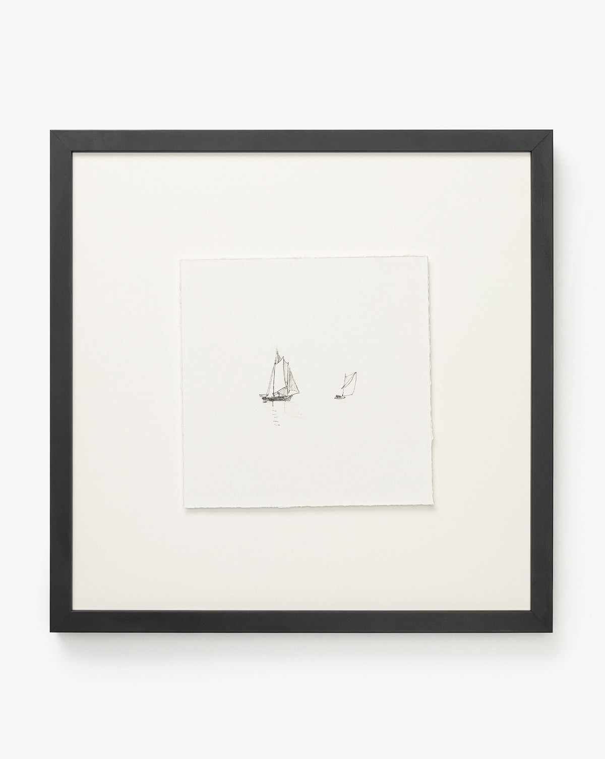 “Sail Away” features a minimalist black and white drawing of two sailboats on water, centered on square white paper with a black wood frame and wide white mat—ideal for lovers of small ship art, by McGee & Co.