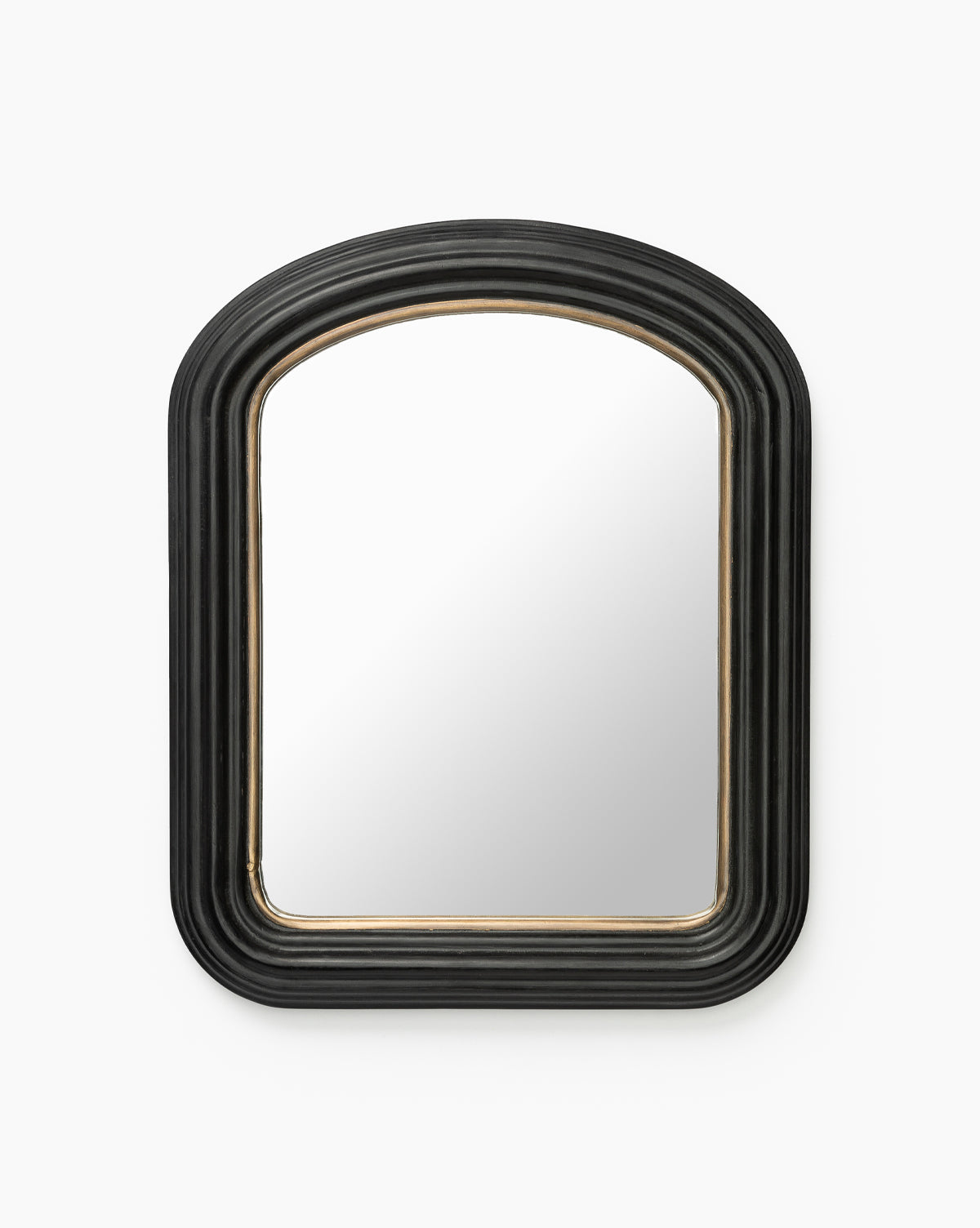 The Samuel Shelf Mirror boasts a rectangular shape with a rounded top, thick black ridged frame, and subtle gold inner edge, offering versatile transitional style. Set against a plain white background, it elevates any space by McGee & Co.