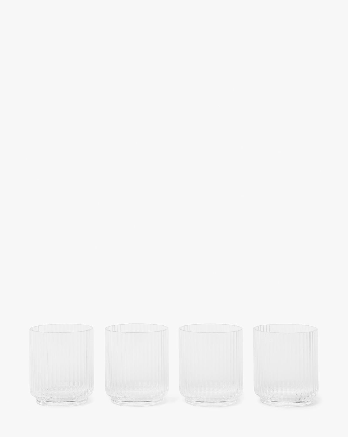The Sanibel Acrylic Tumblers (Set of 4) feature a clear, vertical ribbed design and are shown in a row against a white background—ideal for stylish outdoor table settings.