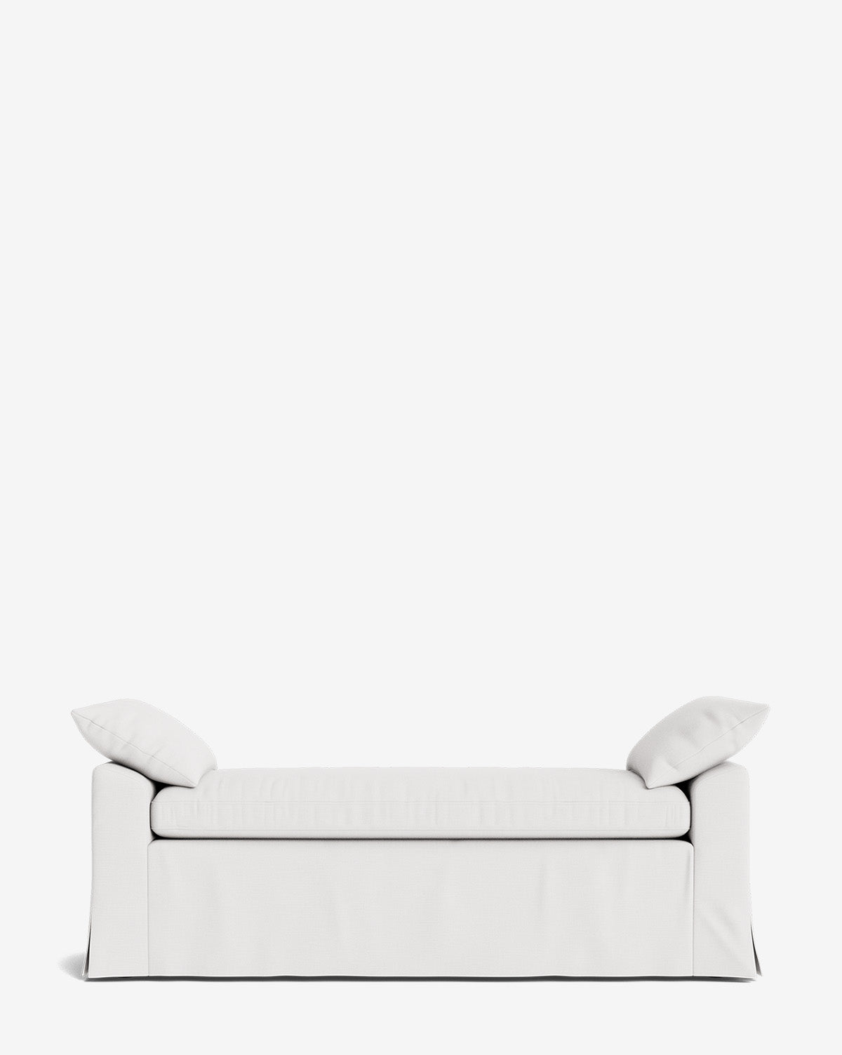 The Scaletta Bench is a minimalist white bench with two matching cushions at each end, set against a plain white background. Its modern, skirted design is crafted with performance fabrics for lasting durability, by McGee & Co.