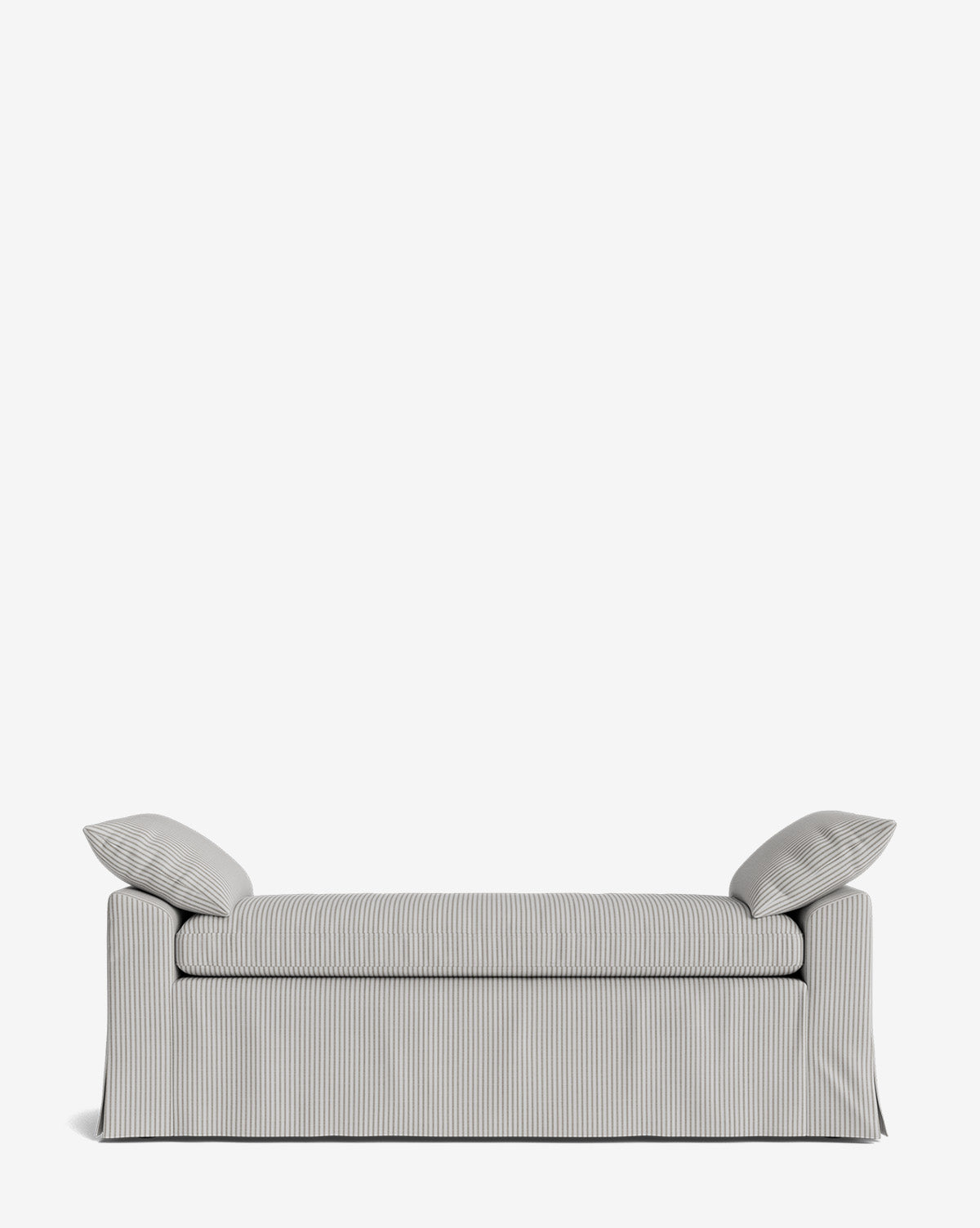 The Scaletta Bench is upholstered in performance fabric with stripes, two matching pillows, and a skirted base. Its clean lines and modern look are highlighted against a plain white background for a crisp appearance by McGee & Co.