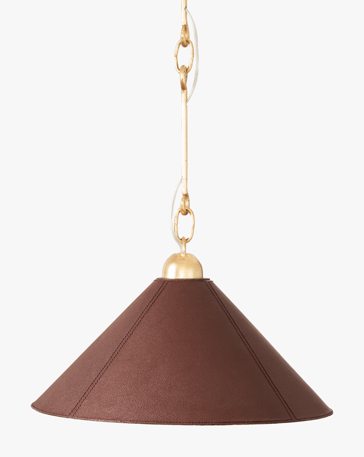 The Scarlett Pendant showcases a wide conical brown leather shade with gold leafed iron fixtures, hanging from a gold chain for an elegant look against a white backdrop, by McGee & Co.