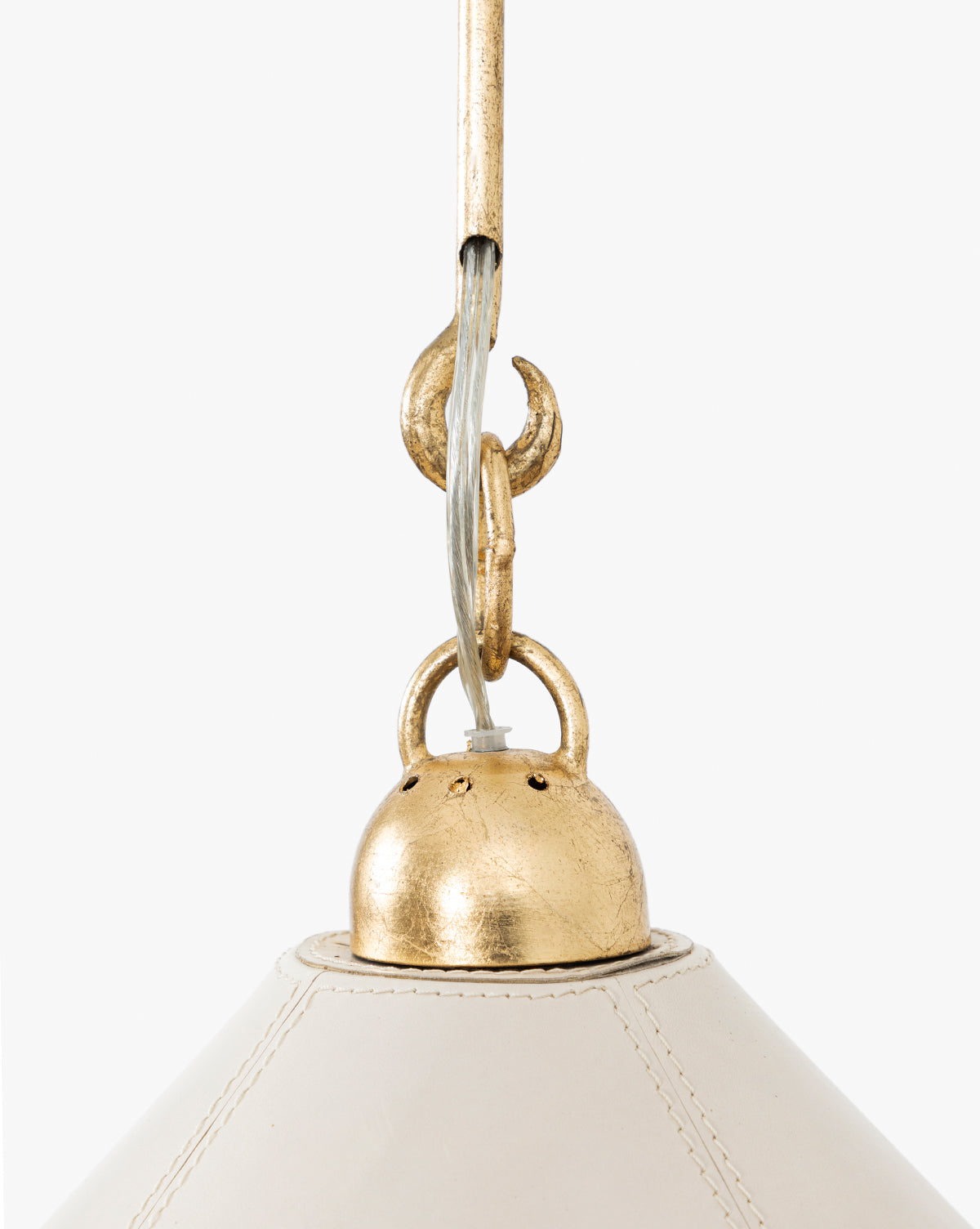 Close-up of the Scarlett Pendant, showcasing its elegant gold leafed iron accents, white cloth-wrapped cord, and white shade against a plain background, by McGee & Co.