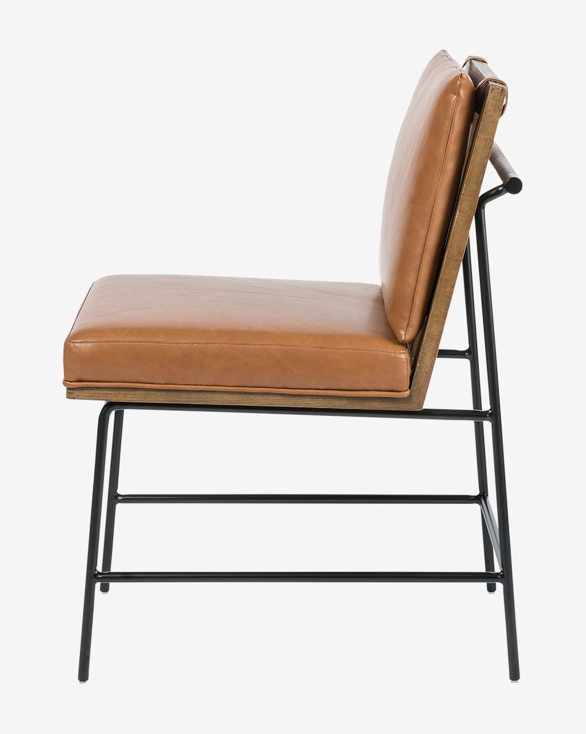 Side view of the Selas Dining Chair featuring a tan leather cushion and backrest, black iron frame, and wooden accents, displayed against a plain white background, by McGee & Co.