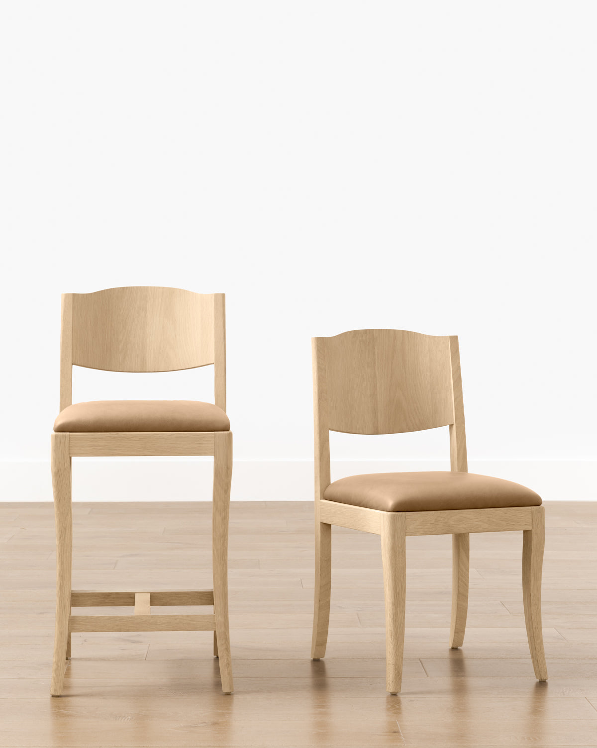 A Shepherd Dining Chair with a white oak frame and upholstered seat, along with a barstool, both featuring curved backrests, sit on a light wood floor against a white wall by McGee & Co.