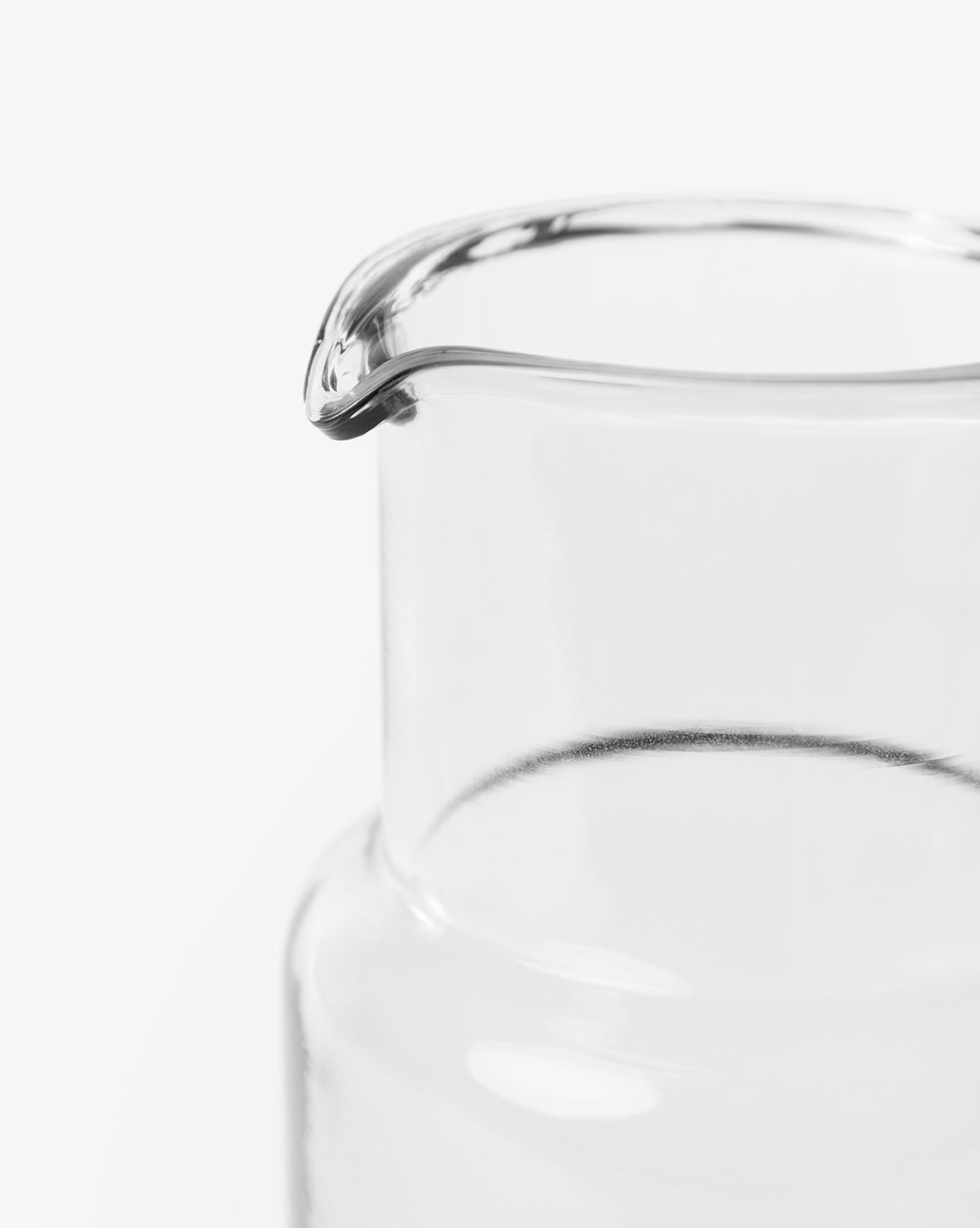 Close-up of the top portion of the Sienna Carafe, featuring a hand-blown glass design and spout, set against a plain white background by McGee & Co.