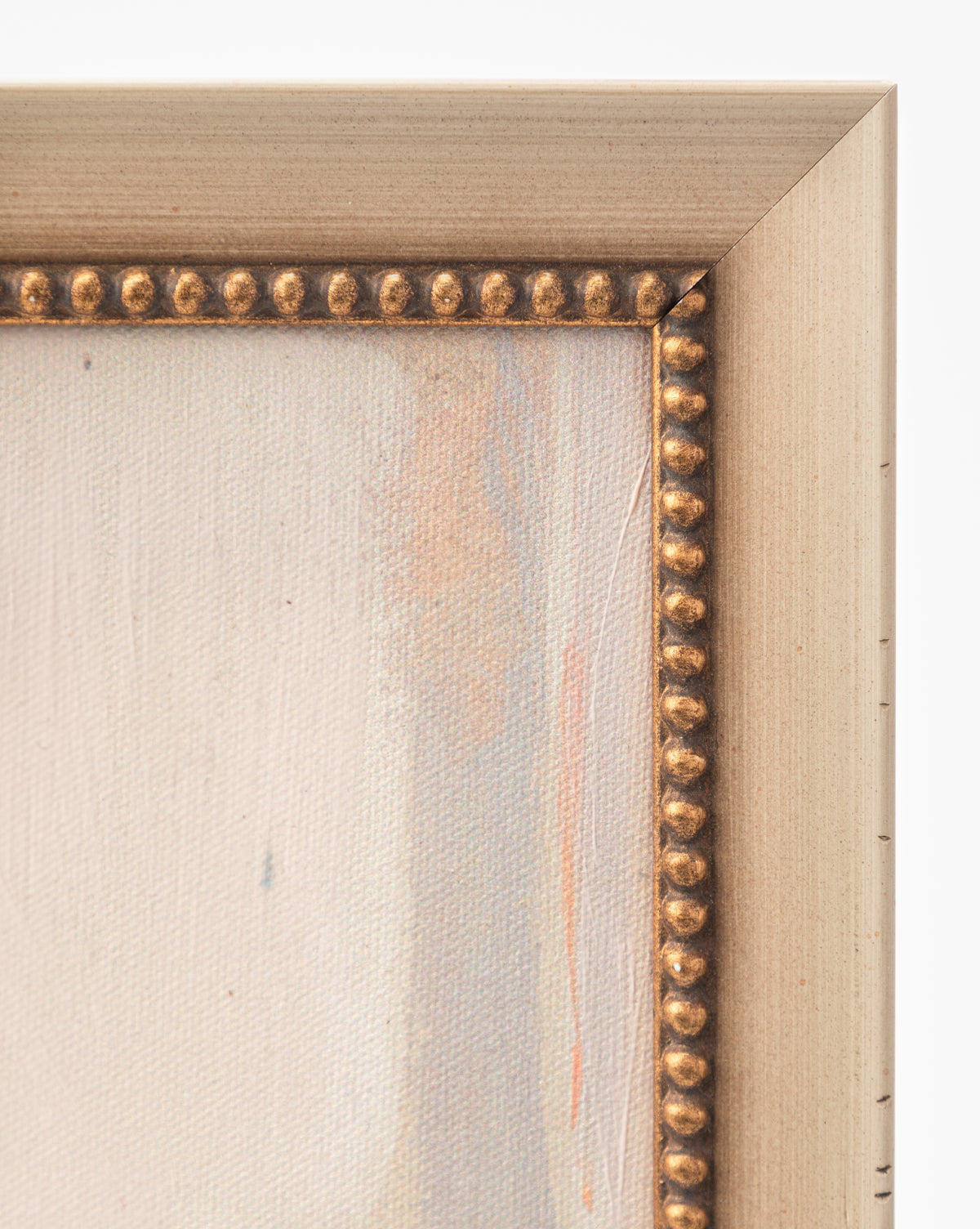 Close-up of the top right corner of Single Blossom. The light gold frame features a decorative beaded inner edge, complementing the canvas’s soft neutral tones and evoking the gentle elegance of this romantic artwork, by McGee & Co.