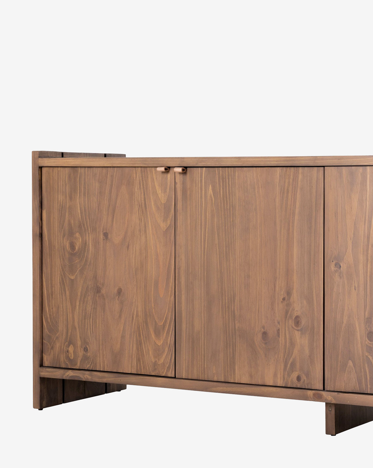 The Sloane Sideboard, crafted from solid pine with two panel doors and visible wood grain, is shown partially from the left side against a plain white background by McGee & Co.