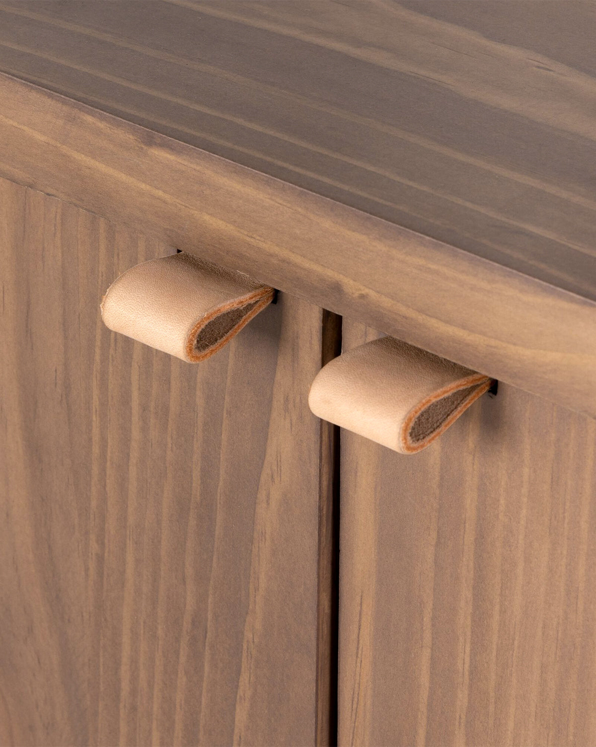 Close-up of two tan leather pulls on the Sloane Sideboards natural wood grain doors—a stylish upgrade for European midcentury or solid pine interiors, by McGee & Co.