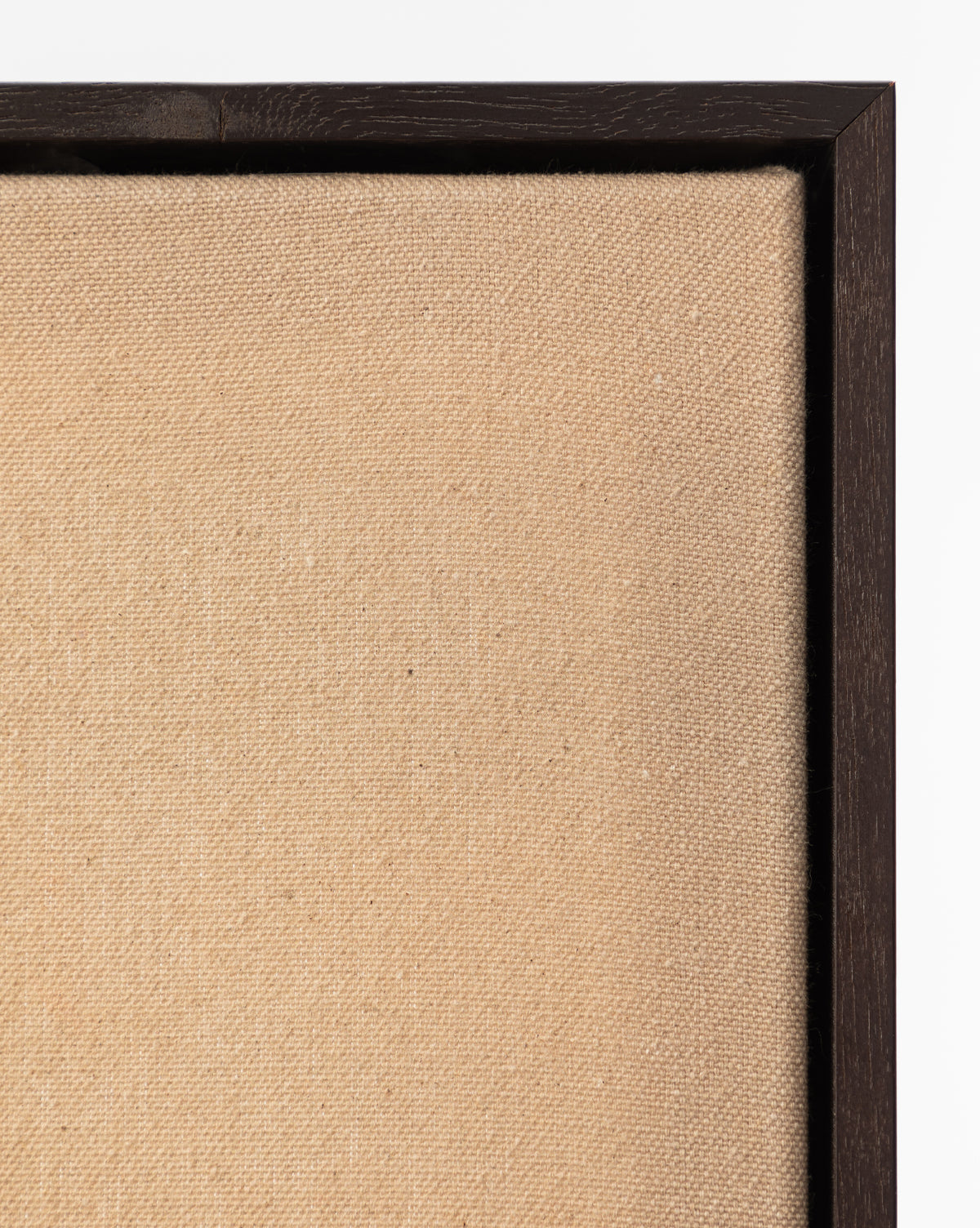 Close-up of the top left corner of Smokey Pasture, an empty beige canvas in a dark wooden frame, highlighting wall art texture against a white background, by McGee & Co.