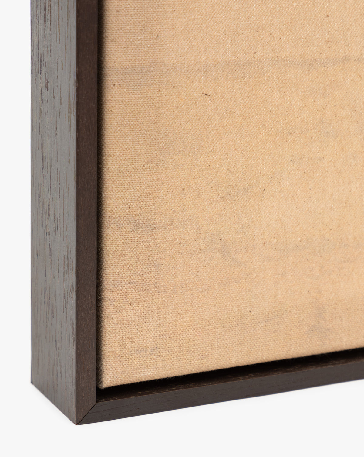 Close-up of the corner of Smokey Pasture—a blank, textured beige canvas in a dark wooden frame—ideal as minimalist wall art or as the base for your next country landscape giclee print, by McGee & Co.