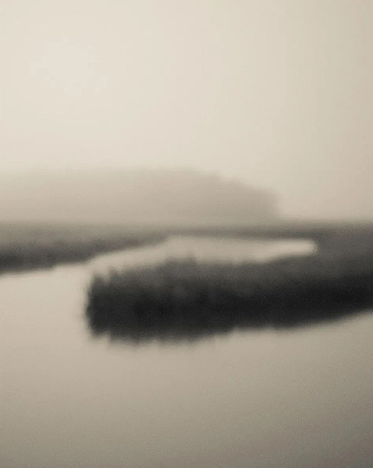 Soft Atlantic Coast by Susan Currie features a blurred, monochrome view of a winding river with reeds and distant trees beneath a hazy sky, presented as a gallery-quality giclee on canvas, by McGee & Co.