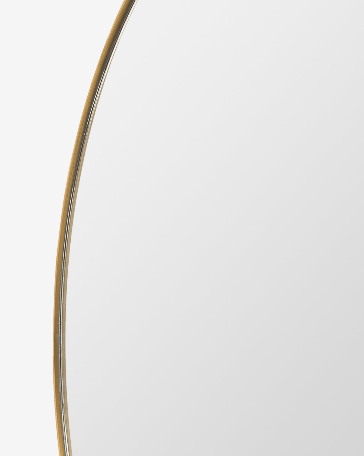A close-up of the Solange Mirror shows its modern, minimalist style with a thin stainless steel frame against a white background. Only part of the round mirror is visible, highlighting its contemporary design, by McGee & Co.