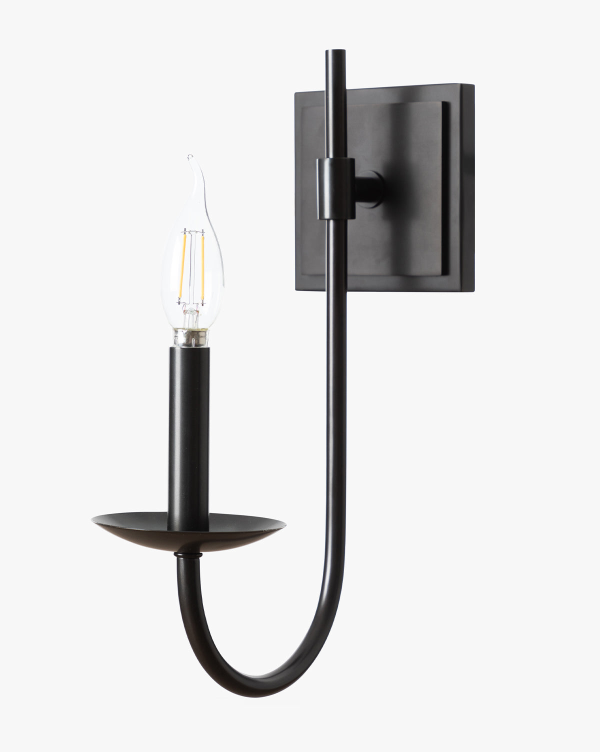 The Makerspalm Southwark Sconce features a modern black finish, square backplate, and curved arm with a candelabra-style bulb on a flat round base, shown against a plain white background. McGee & Co.
