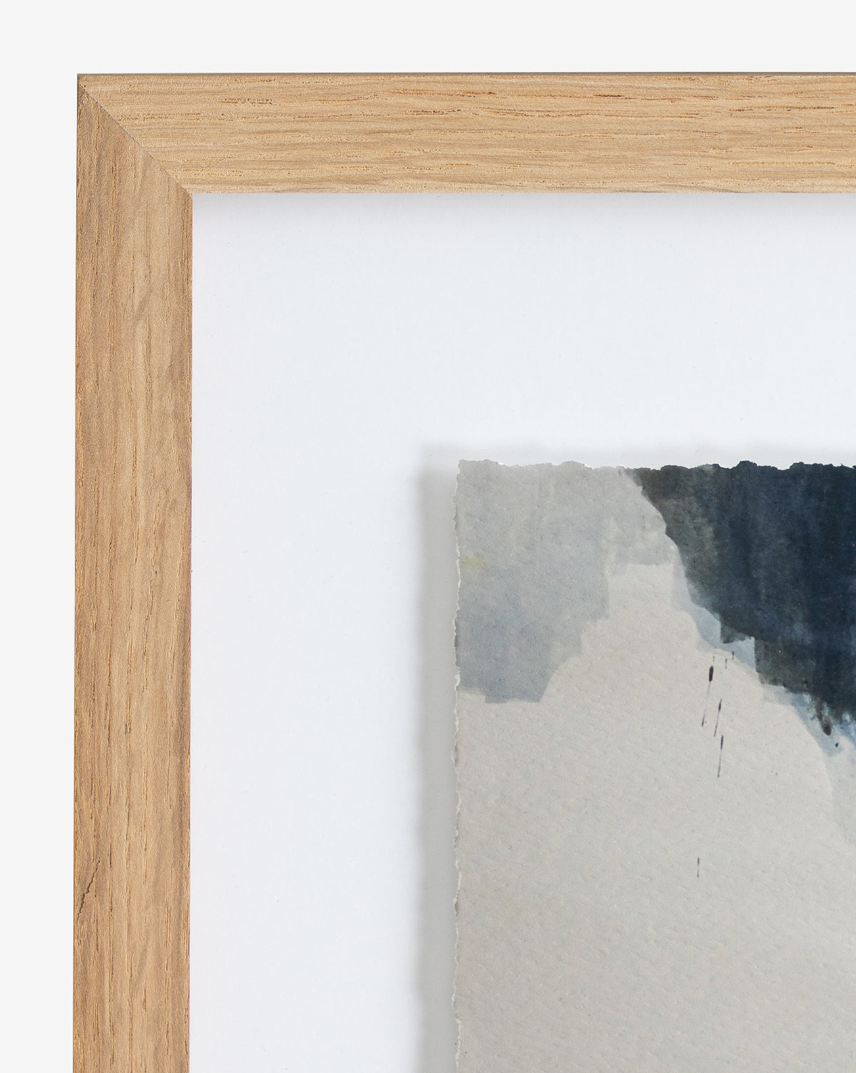 Close-up of the Space Study wood-framed abstract art, showcasing soft gray, blue, and dark tones. The textured edge of the fine art paper stands out against a white background.