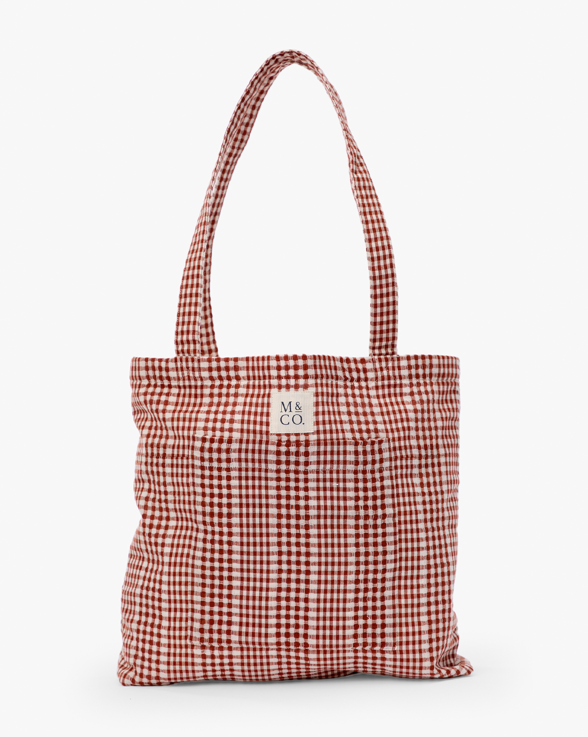 The Spencer Tote Bag is a red and white gingham bag with two handles and a small white label reading "M & CO." on the front, displayed against a plain white background, by McGee & Co.