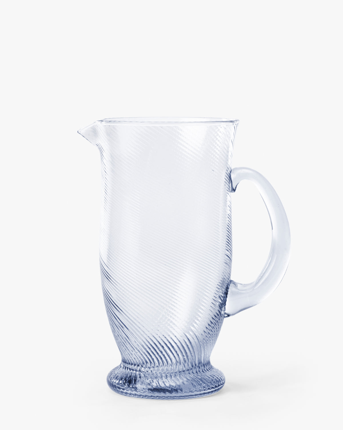 The Spiral Jug features a handcrafted glass design with a curved handle, wide base, and diagonal textured pattern—an eye-catching addition to any tabletop, shown against a plain white background by McGee & Co.