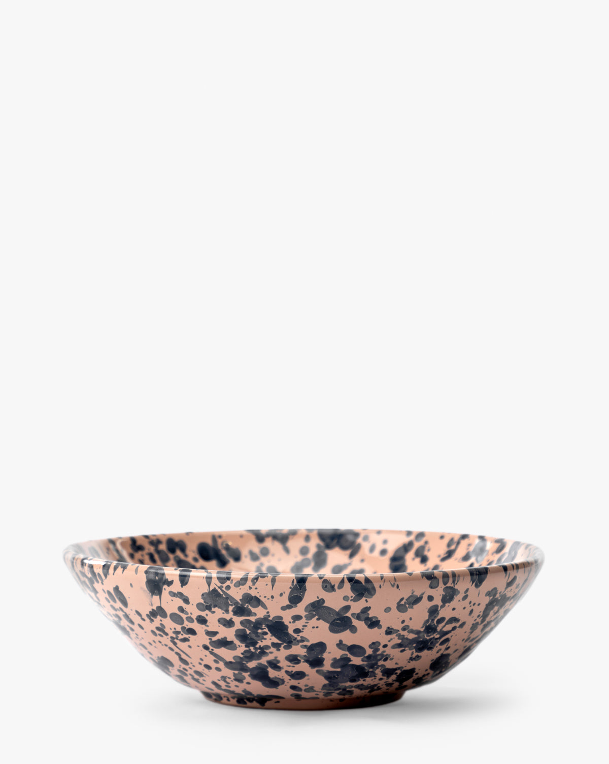 The Splatter Large Bowl is a handcrafted ceramic piece featuring a beige base with black splatter design, shown on a plain white background, by McGee & Co.