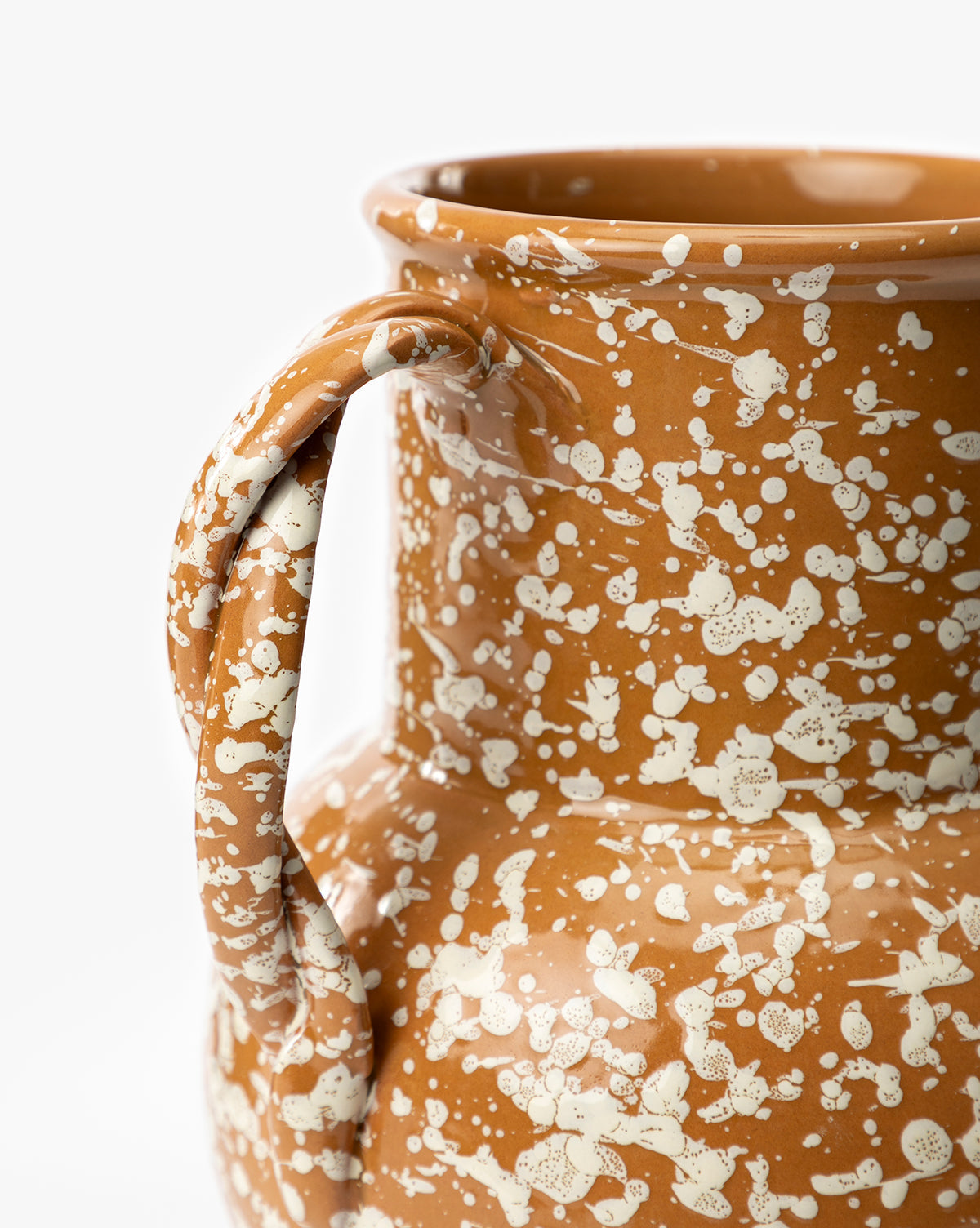 Close-up of the Splatter Verona Vase, a handmade ceramic jug with a single handle, featuring a brown base and white speckles, shown against a plain white background, by McGee & Co.