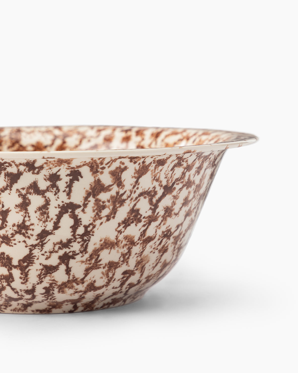 A close-up of the Spongeware Bowl shows its speckled brown and cream ceramic glaze, with only part of the side and rim visible against a white background, by McGee & Co.