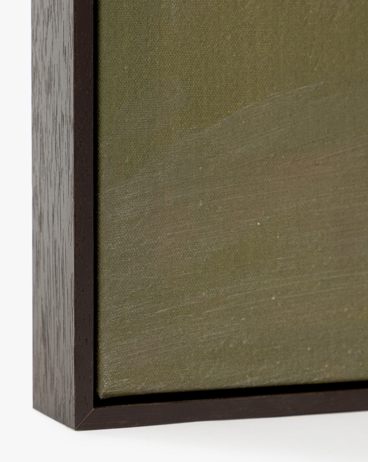 Close-up of the bottom left corner of Spring Skies, a gallery-wrapped canvas artwork featuring textured green and brown tones, elegantly framed in espresso wood.