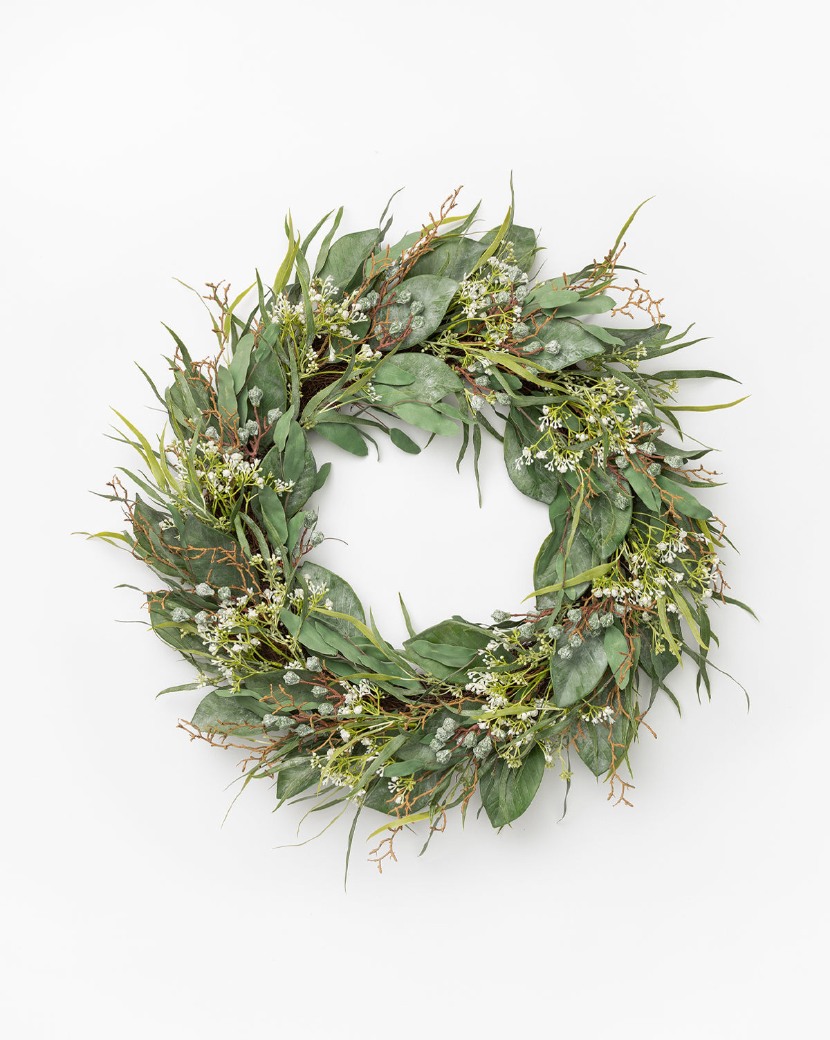 The Faux Wild Grass & Eucalyptus Wreath features green leaves, small white flowers, and brown twigs—perfect as a faux greenery spring wreath to refresh your home decor.