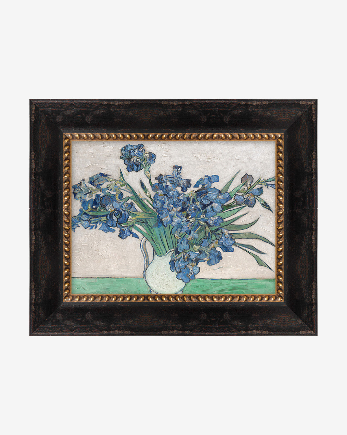 Irises by Van Gogh: a framed floral painting depicting blooming blue irises in a white vase, long green leaves, and a light background with a green stripe, all set in a black and gold wood frame.