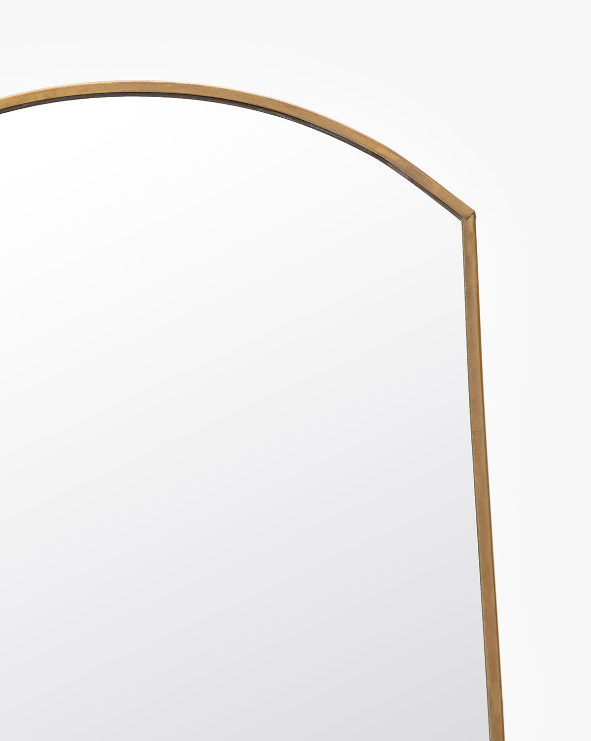 A close-up of the top right corner of the Standing Vanity Mirror, featuring a thin brass-finished metal frame against a plain white background. Ideal as a standing vanity mirror for your bathroom countertop.