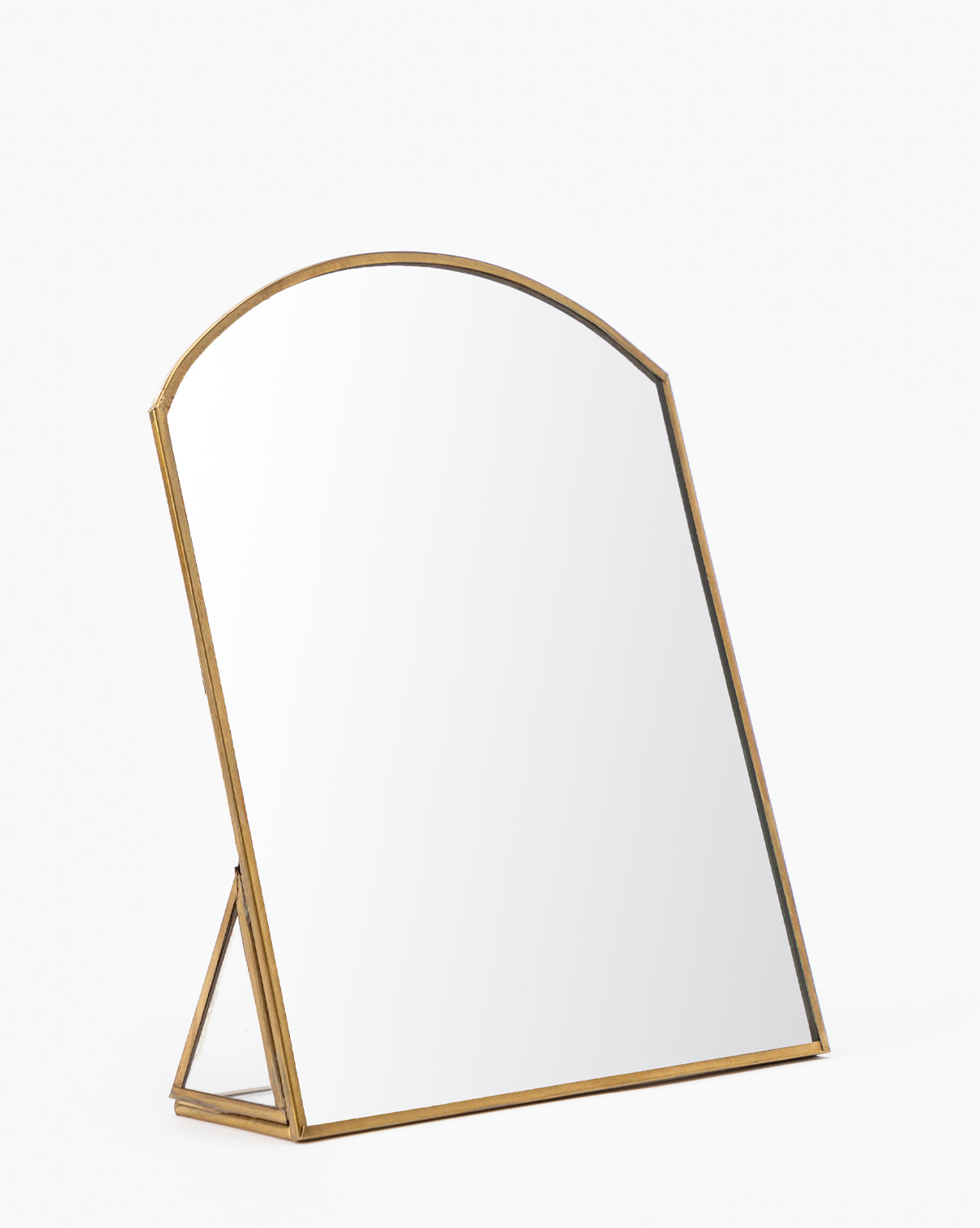 The Standing Vanity Mirror features a rounded top and a light wood frame, set on a simple support stand—ideal for any bathroom countertop—shown against a plain white background.