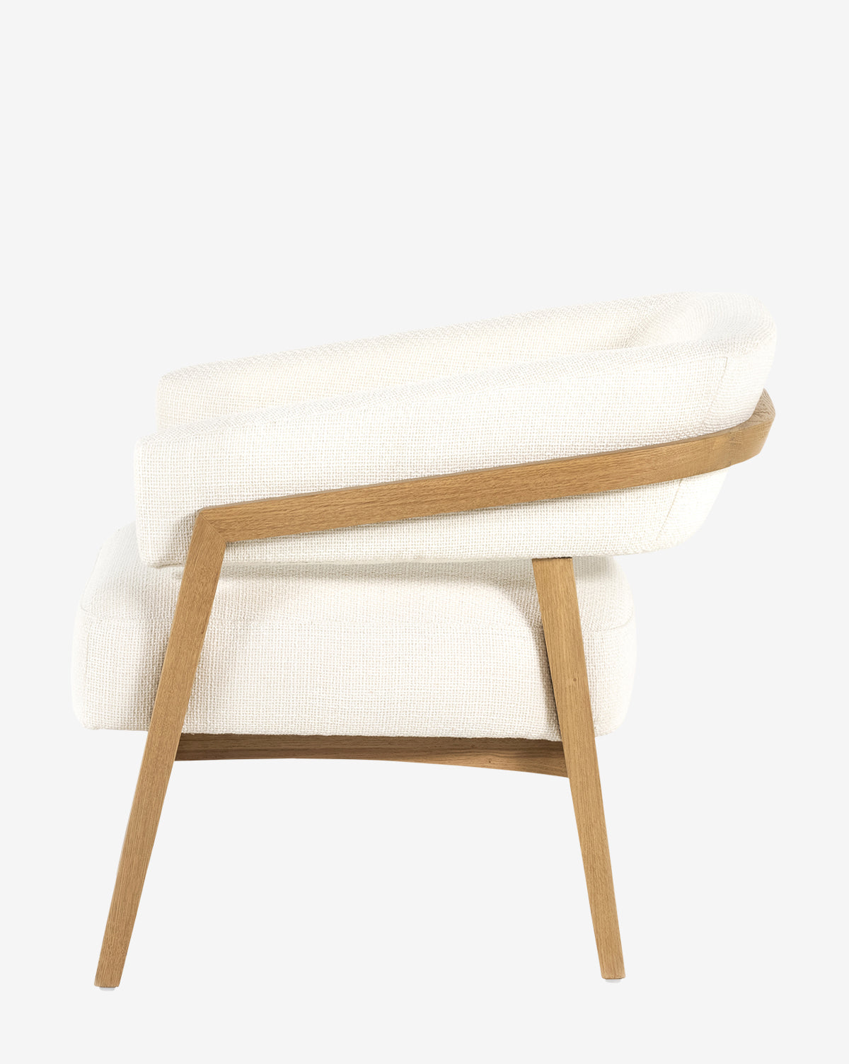 Side view of the Stanley Lounge Chair, featuring a light cream upholstered seat and backrest with an angled wooden frame, highlighting contemporary design against a plain white background, by McGee & Co.