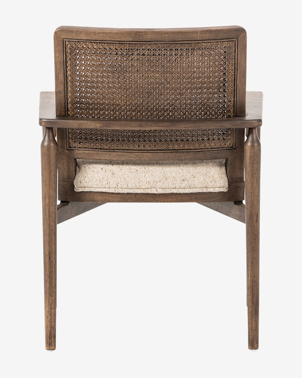 The Zalan Dining Armchair is shown from behind, highlighting its woven cane back, light-colored upholstered seat, and slightly angled legs by McGee & Co.